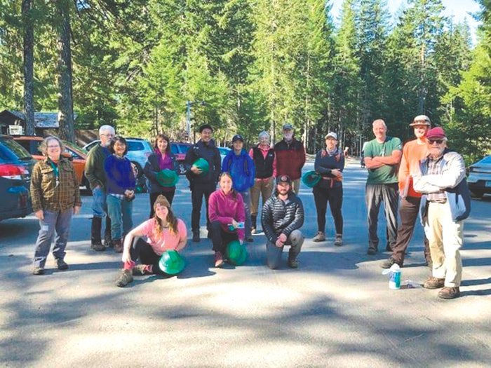 Volunteers learn about their plans during a trail work day at Mount Rainier National Park.